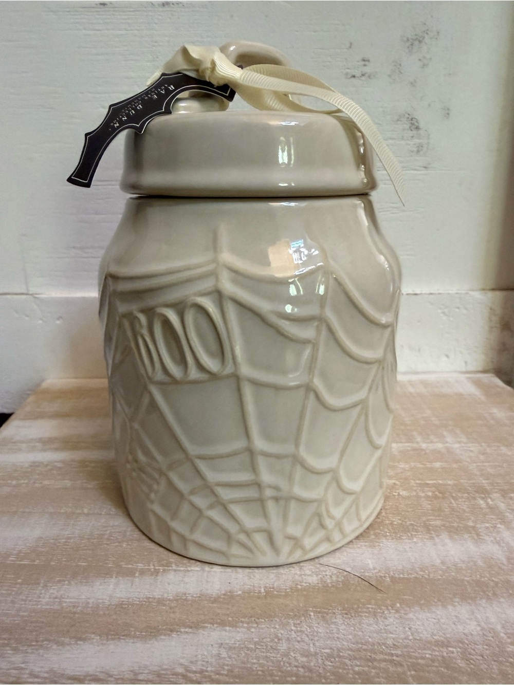 Rae Dunn Halloween canister with spider web and “boo”